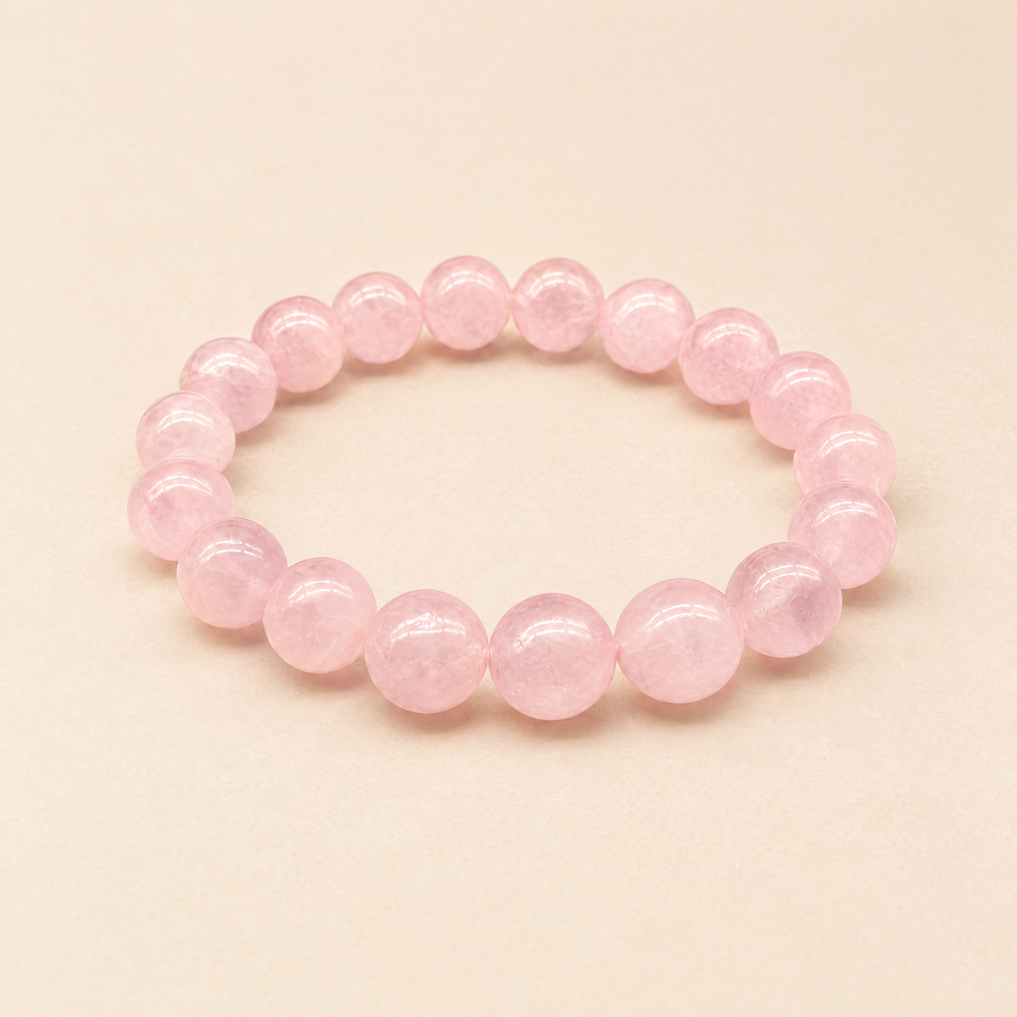Self-Love rose quartz bracelet on a cream background