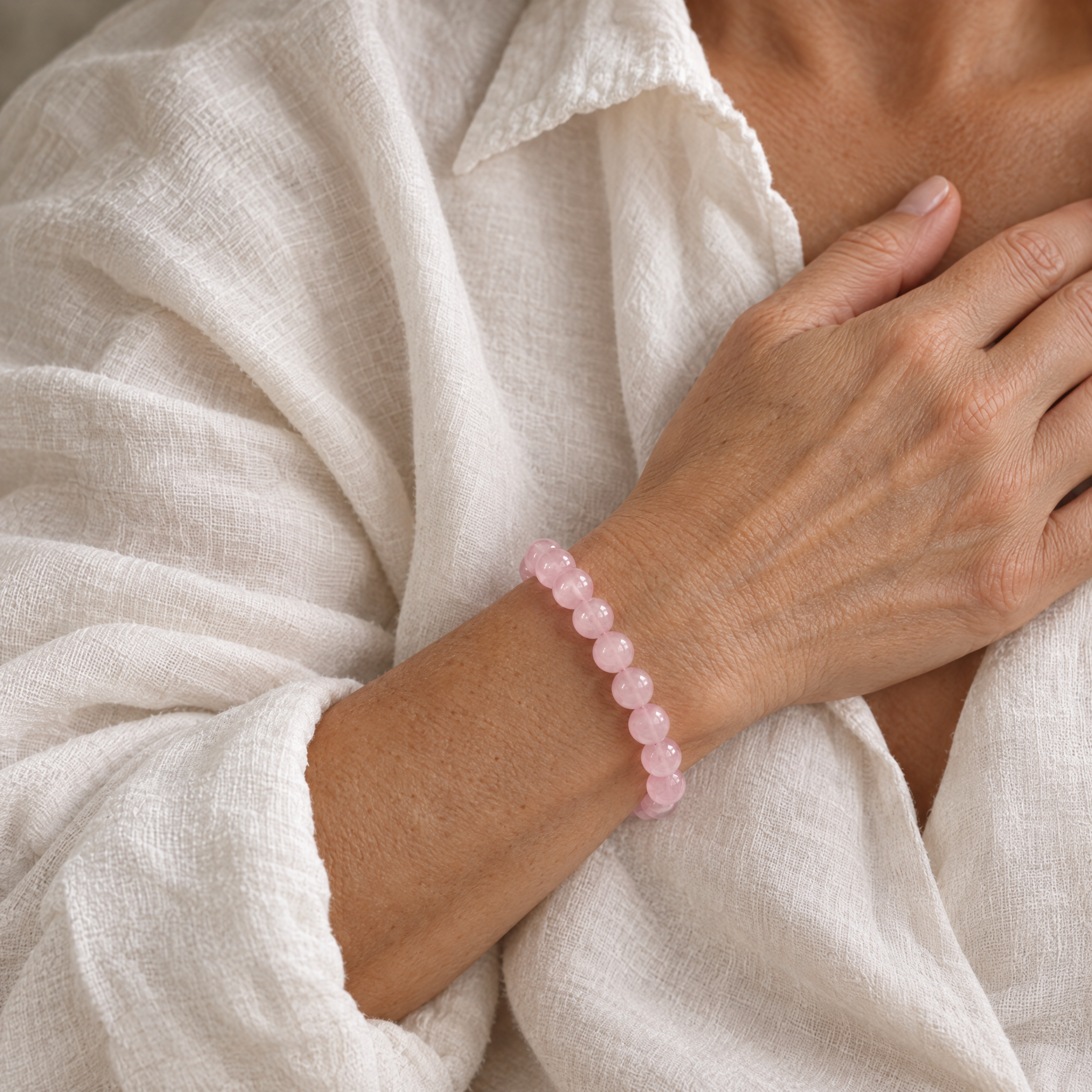 Woman wearing the rose quartz bracelet in soft daylight